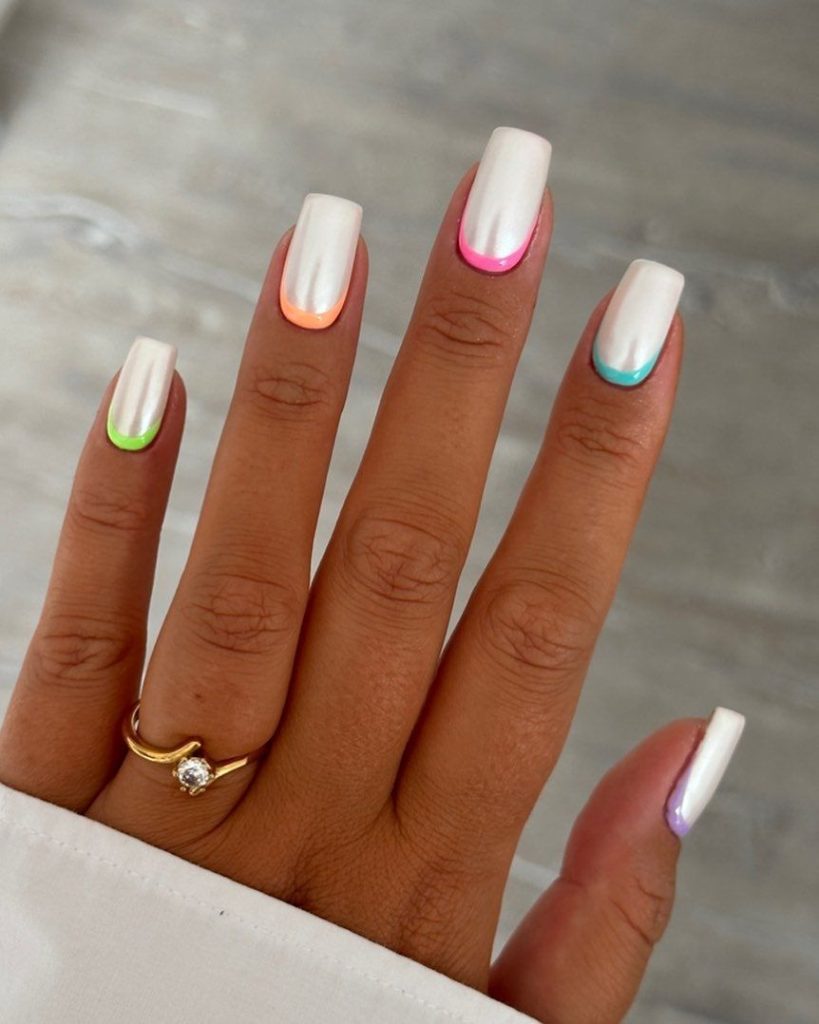 طراحی سفید ناخن با فرنچ نزدیک به انگشت رنگارنگ
